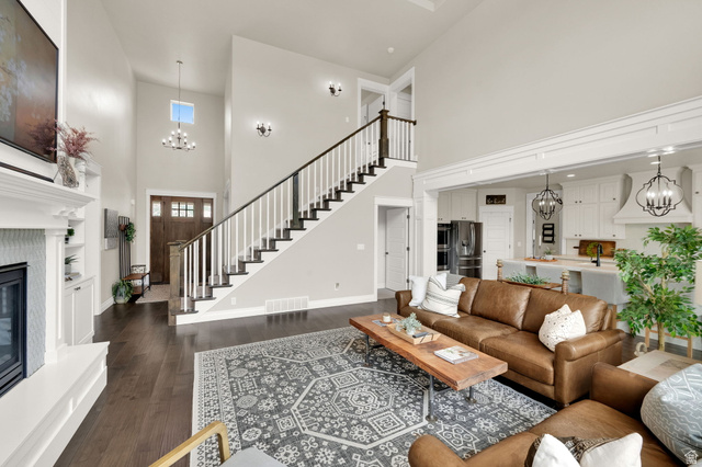 1132 South 1300th Street West Mapleton, UT 84664 - Photo 6 of 52 Spacious living area featuring high ceilings, dark wood-finish flooring, and a fireplace with built-in cabinetry