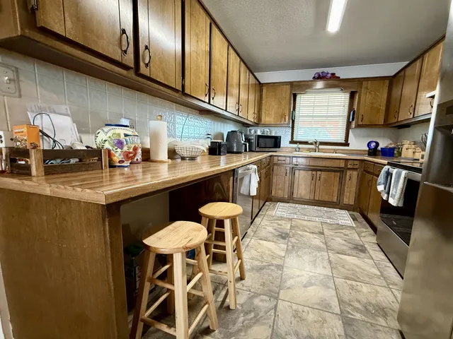 a kitchen with lots of counter top space and a window