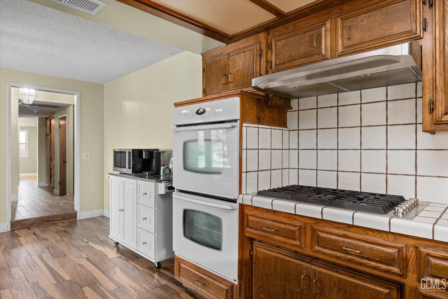 Undisclosed Address Bakersfield, CA 93308 - Photo 11 of 33 a kitchen with a stove and a microwave