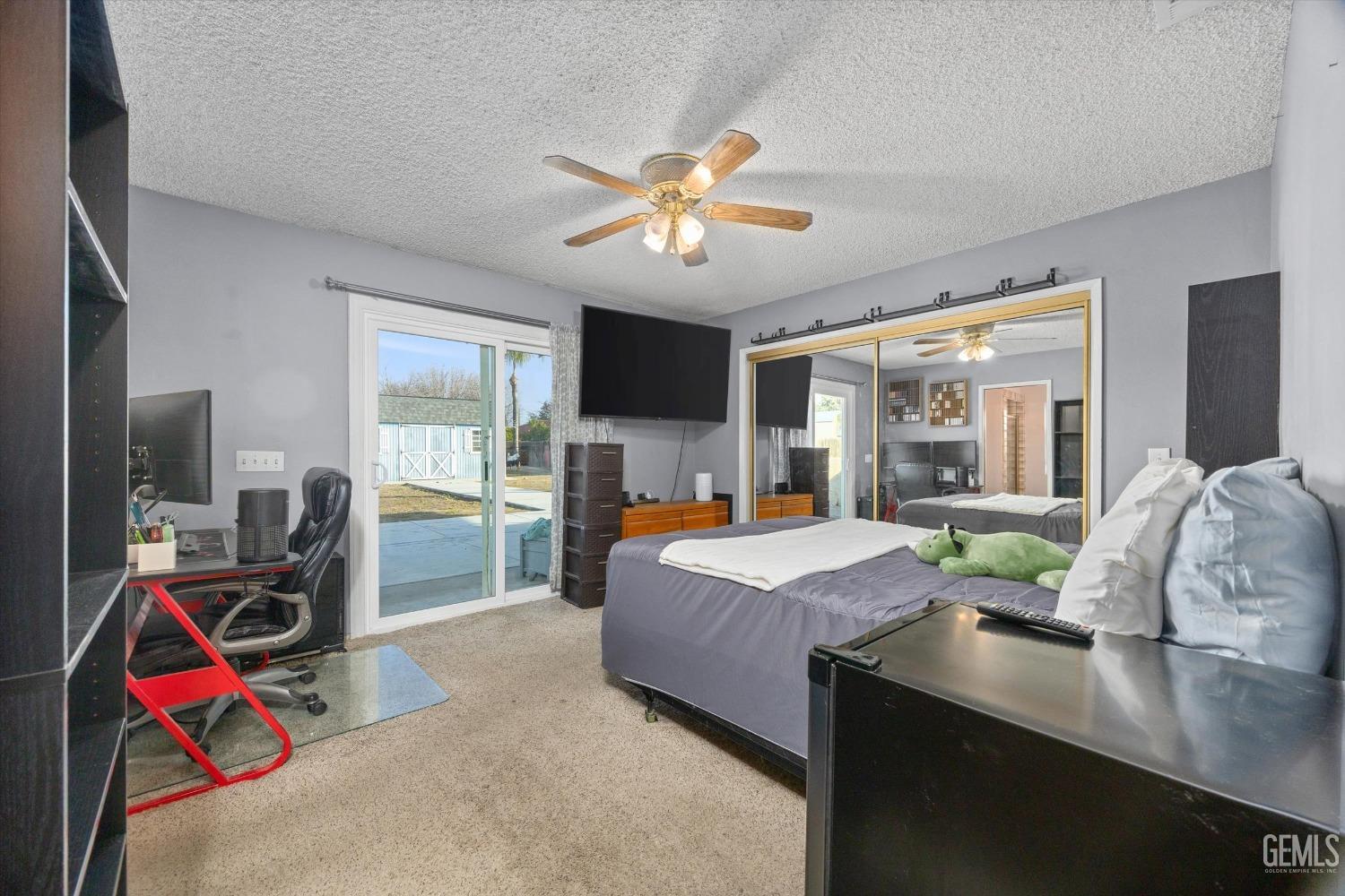 Undisclosed Address Bakersfield, CA 93308 - Photo 13 of 33 a bed room with furniture and a flat screen tv