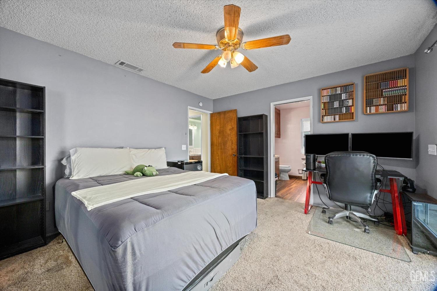 Undisclosed Address Bakersfield, CA 93308 - Photo 14 of 33 a bedroom with a bed and a chandelier