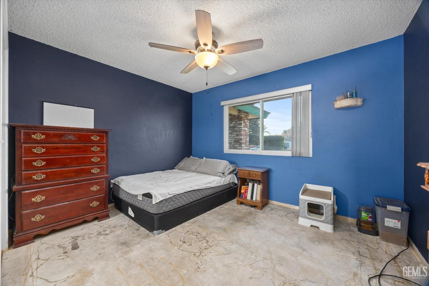 Undisclosed Address Bakersfield, CA 93308 - Photo 16 of 33 a bedroom with a bed and a chandelier