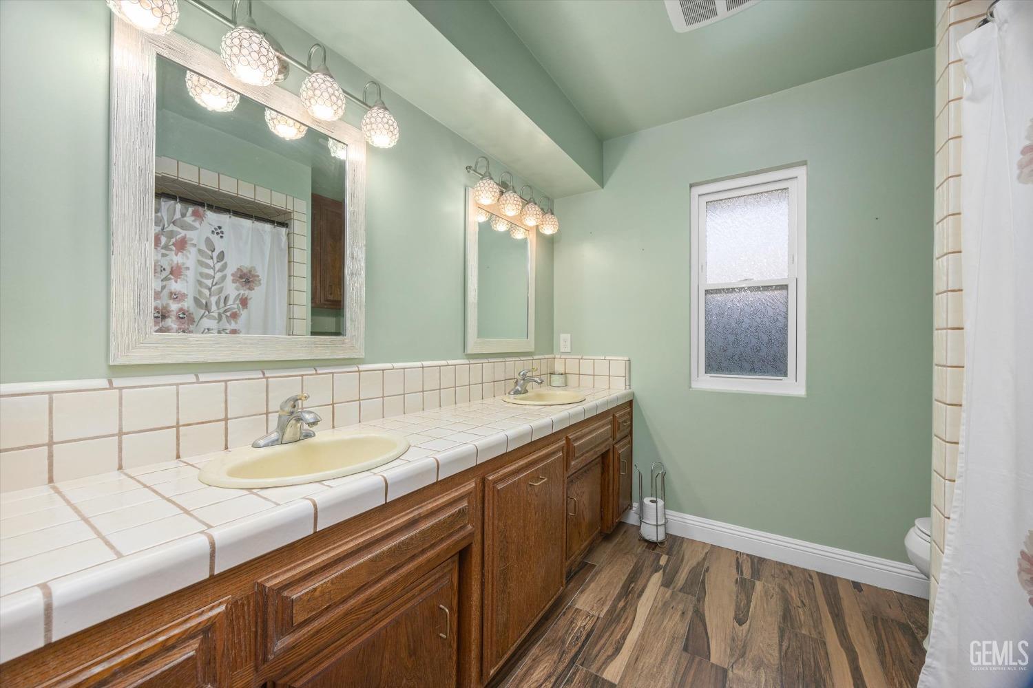 Undisclosed Address Bakersfield, CA 93308 - Photo 17 of 33 a bathroom with a sink and a mirror