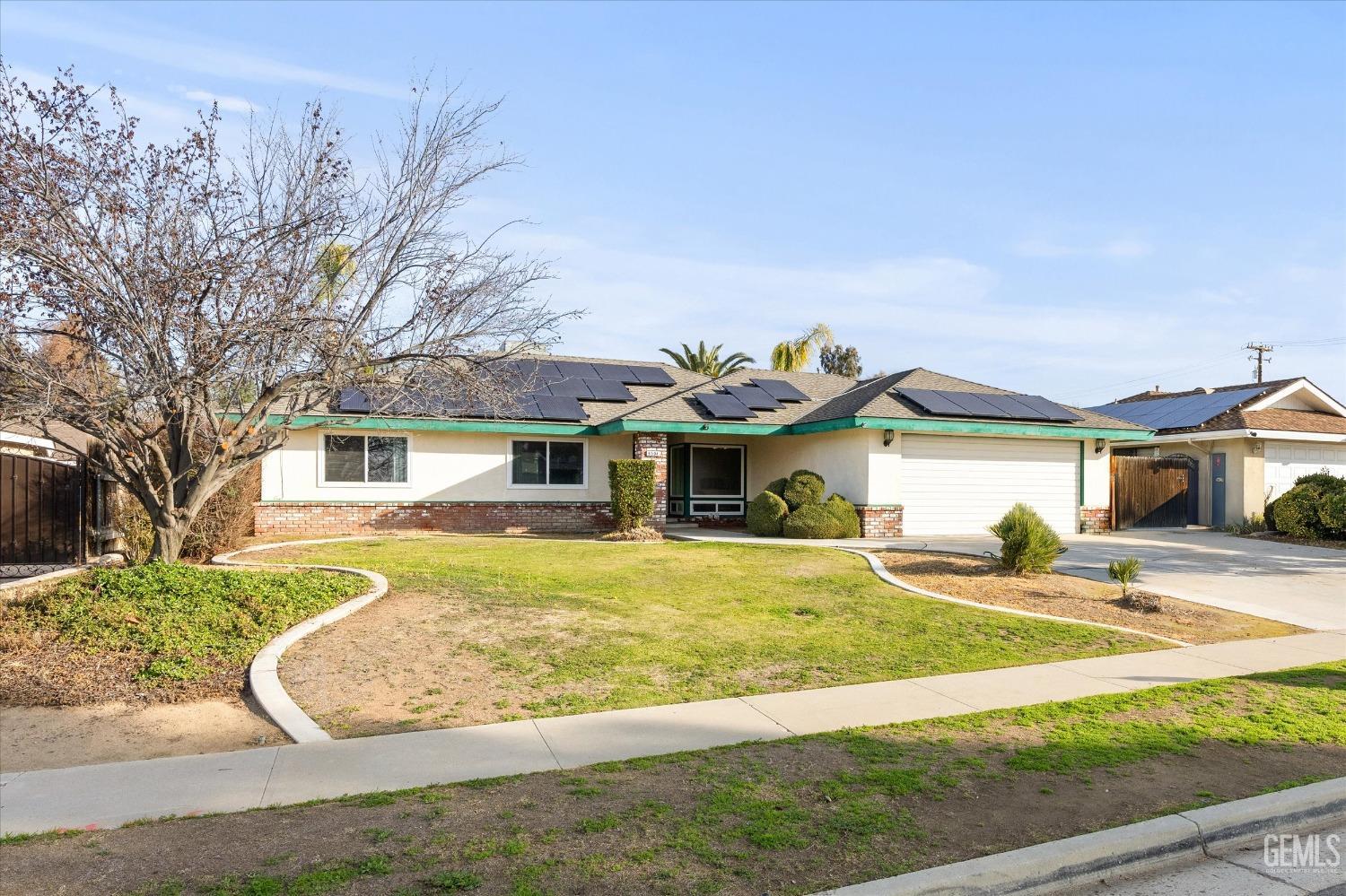 Undisclosed Address Bakersfield, CA 93308 - Photo 26 of 33 a front view of a house with a yard and garage