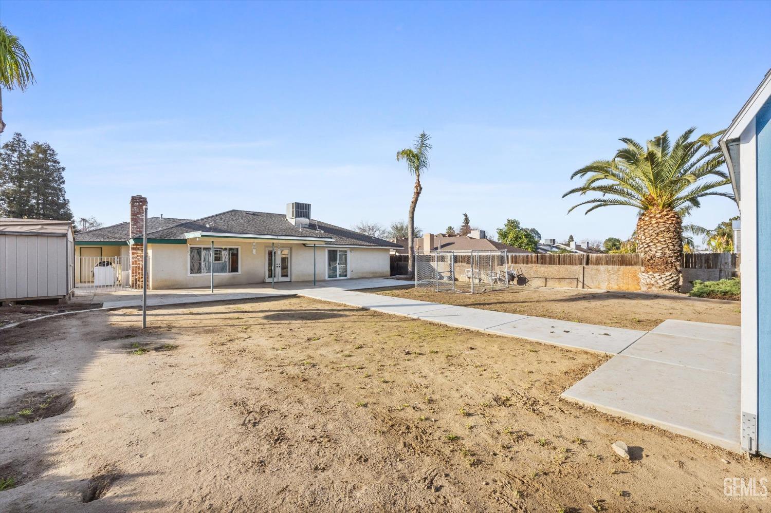 Undisclosed Address Bakersfield, CA 93308 - Photo 28 of 33 a view of a swimming pool with a lawn chairs and a fire pit