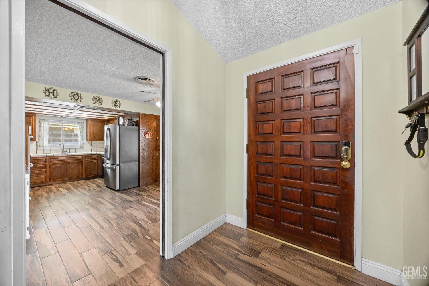 Undisclosed Address Bakersfield, CA 93308 - Photo 3 of 33 a view of a hallway with wooden floor and closet