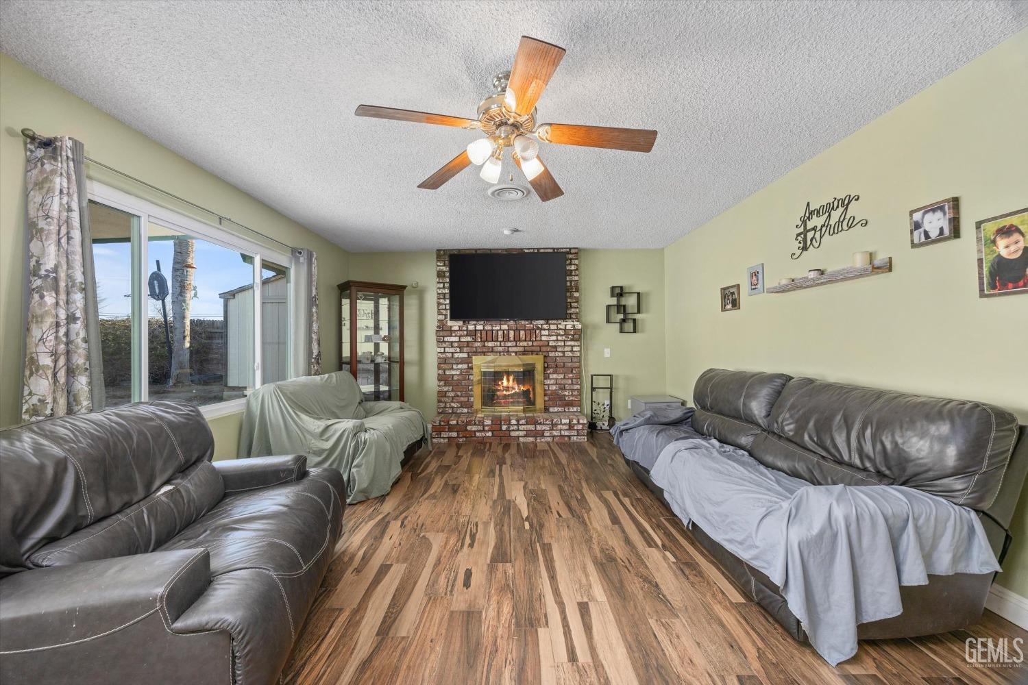 Undisclosed Address Bakersfield, CA 93308 - Photo 6 of 33 a living room with furniture and a fireplace