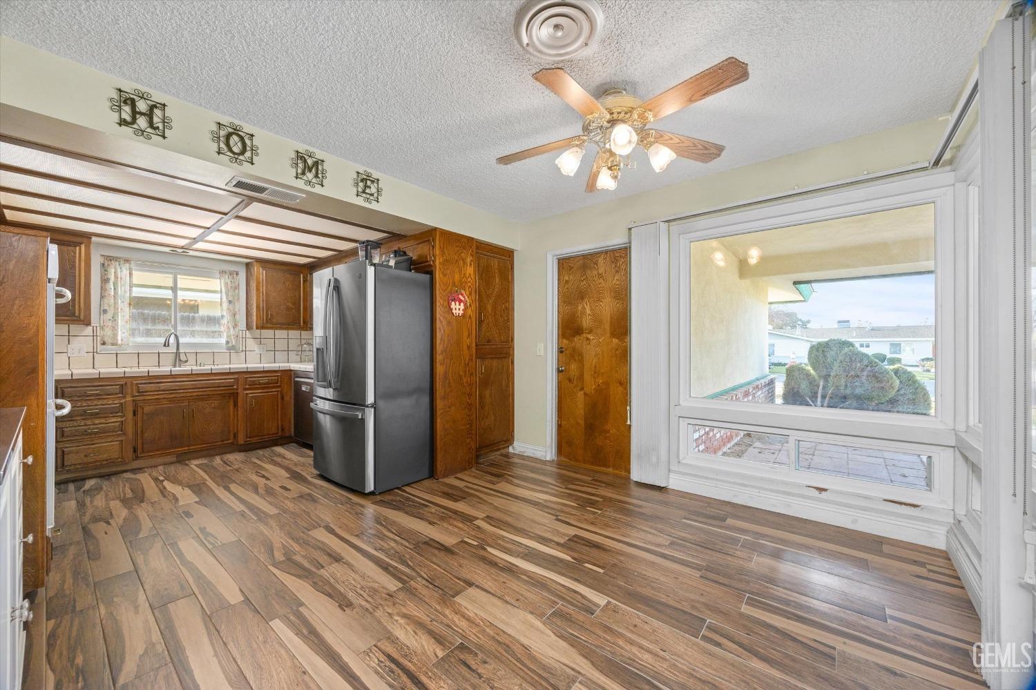 Undisclosed Address Bakersfield, CA 93308 - Photo 9 of 33 a kitchen with a refrigerator and windows
