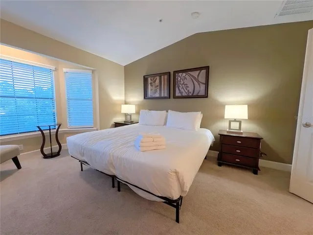 a bedroom with a bed and a night stand