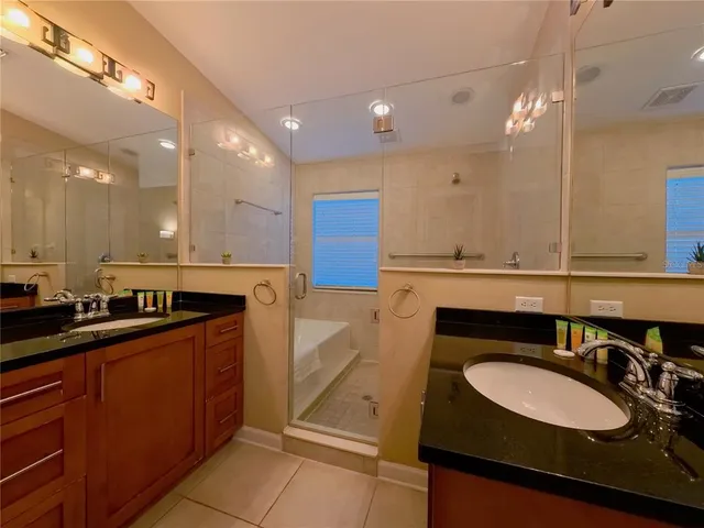 a kitchen with kitchen island granite countertop a sink a stove and cabinets