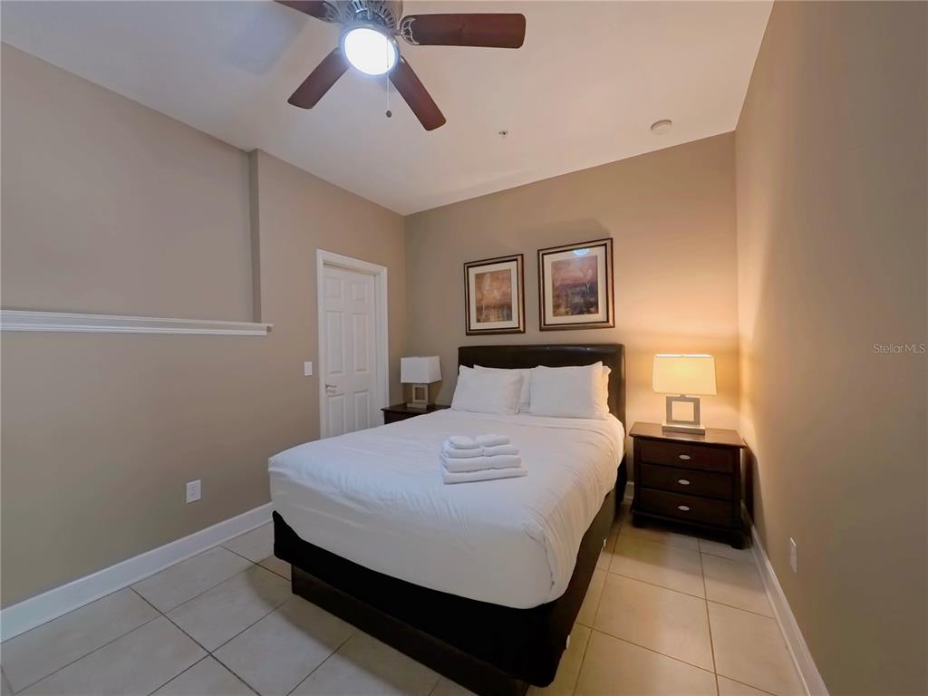 14525 Damai Lane Orlando, FL 32821 - Photo 23 of 30 a bedroom with a bed and a painting on the wall