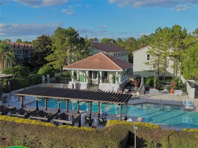 an aerial view of a house with swimming pool and garden