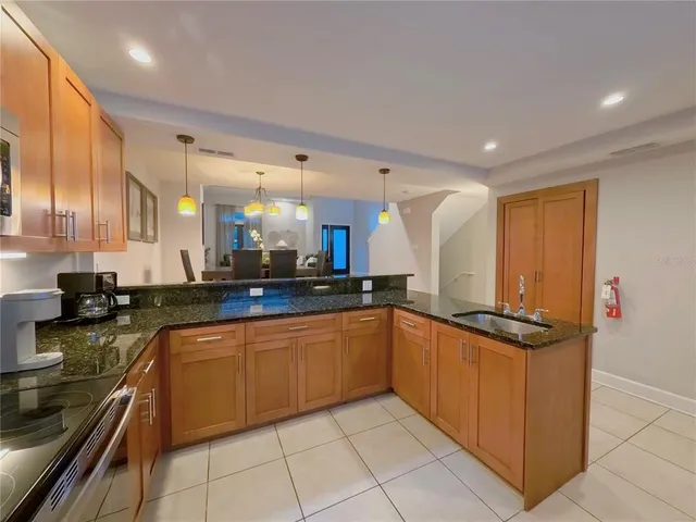 a kitchen with stainless steel appliances granite countertop a sink and cabinets