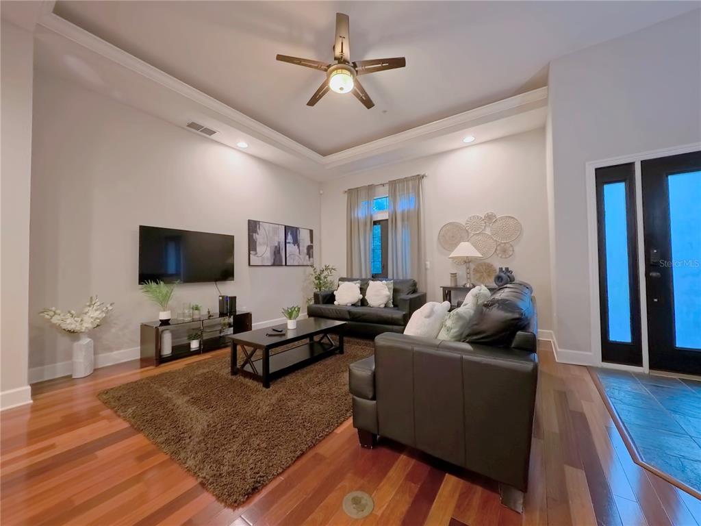 14525 Damai Lane Orlando, FL 32821 - Photo 8 of 30 a living room with furniture and a flat screen tv