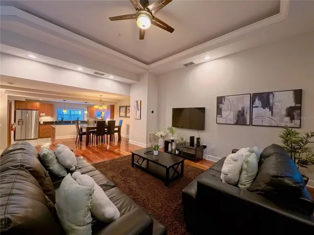 a living room with furniture and view of kitchen