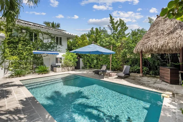 a view of a house with backyard sitting area and garden