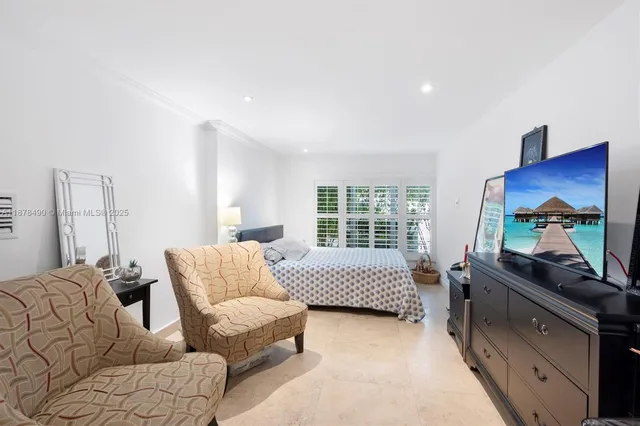a bedroom with furniture and a window