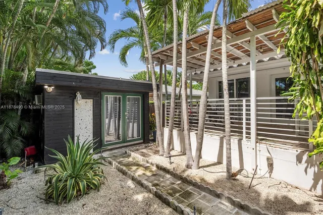 a view of a house with a window and plants