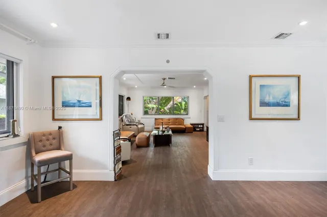 a view of a livingroom with furniture window and wooden floor