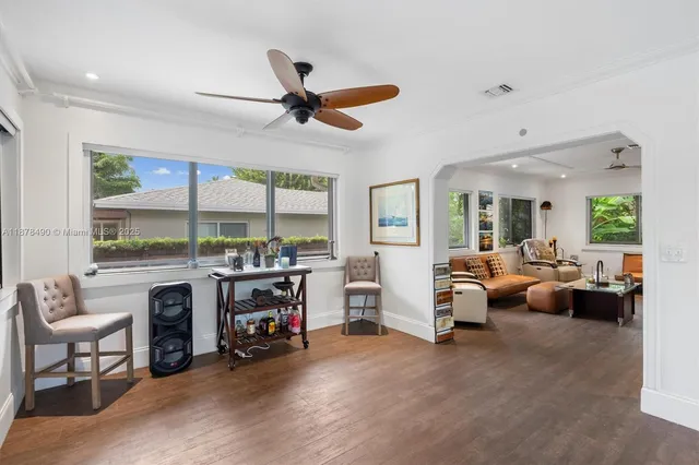 a living room with furniture a fireplace and a large window