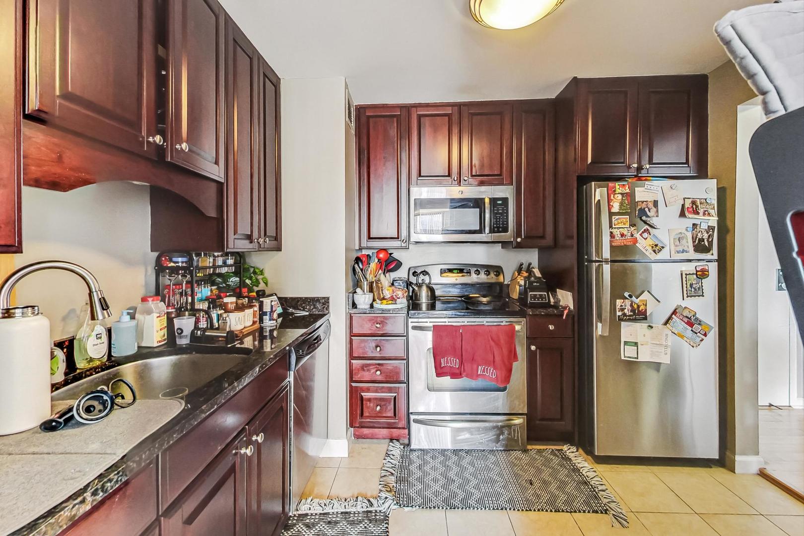 Undisclosed Address Chicago, IL 60601 - Photo 7 of 22 a kitchen with stainless steel appliances granite countertop a refrigerator stove and sink