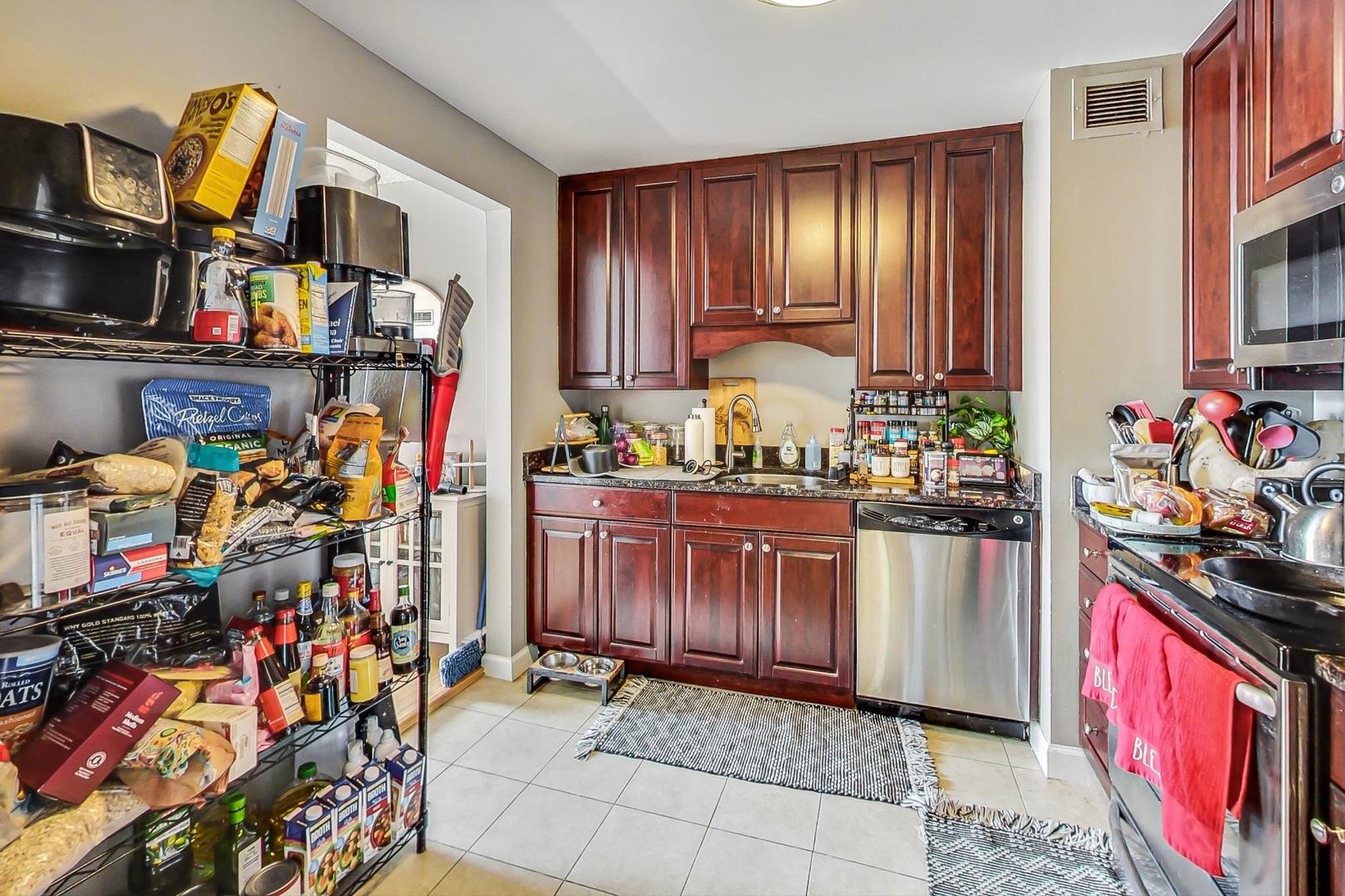 Undisclosed Address Chicago, IL 60601 - Photo 8 of 22 a kitchen with stainless steel appliances granite countertop a refrigerator and a stove