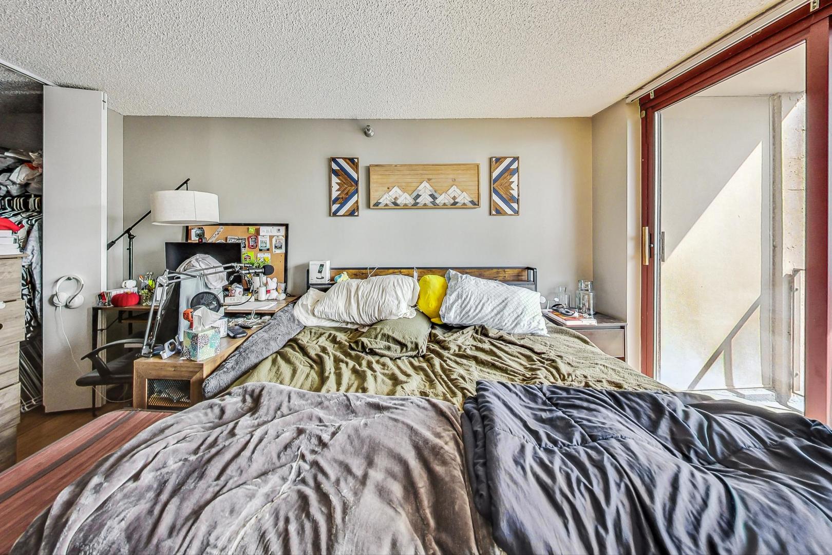 Undisclosed Address Chicago, IL 60601 - Photo 10 of 22 a bed sitting in a bedroom next to a window