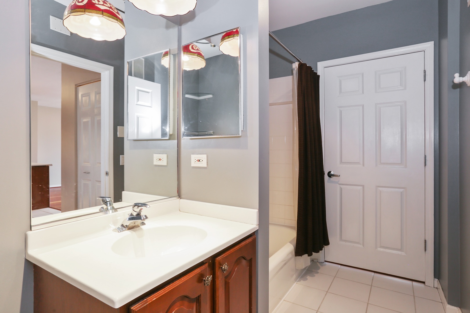 630 North State Street, Unit 1609 Chicago, IL 60654 - Photo 16 of 22 a bathroom with a sink and a mirror