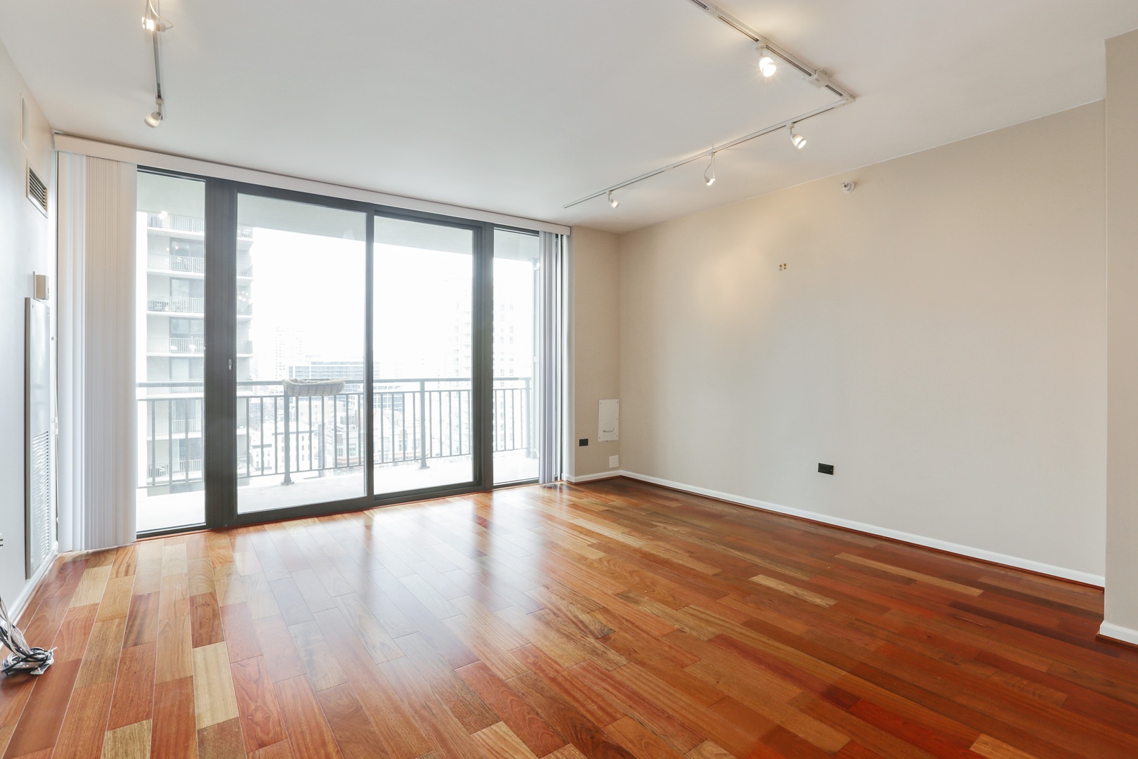630 North State Street, Unit 1609 Chicago, IL 60654 - Photo 6 of 22 wooden floor in an empty room with a window