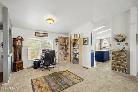 a view of a workspace with furniture and a window