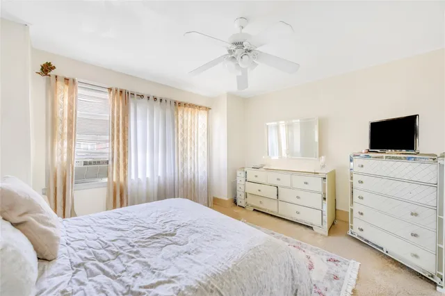 a bedroom with a bed and a flat tv screen in it