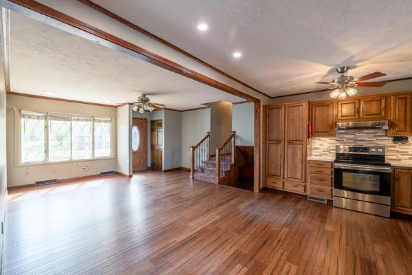 a kitchen with granite countertop stainless steel appliances and wooden cabinets