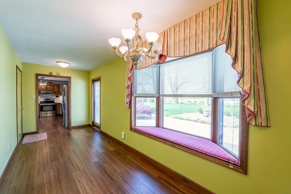 a view of hallway with wooden floor