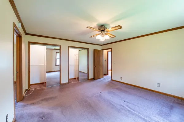 an empty room with windows and closet