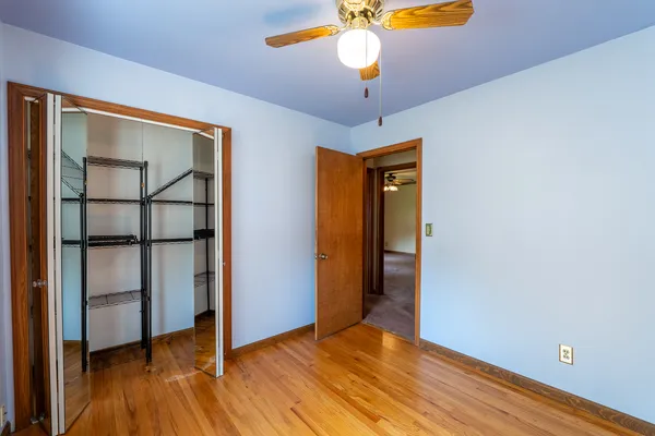 a view of a livingroom with a ceiling fan and window
