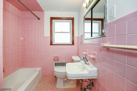 a bathroom with a sink a toilet and tub