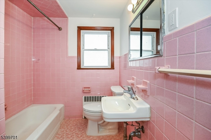 13 Knapp Avenue Clifton, NJ 07011 - Photo 13 of 17 a bathroom with a sink a toilet and tub