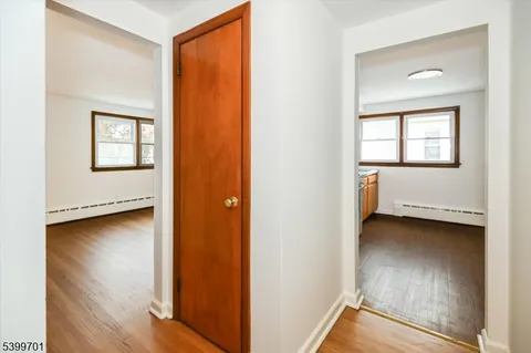 a view of an empty room and wooden floor