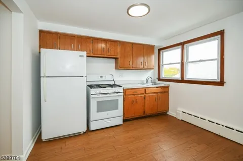 a kitchen with a refrigerator sink stove and cabinets