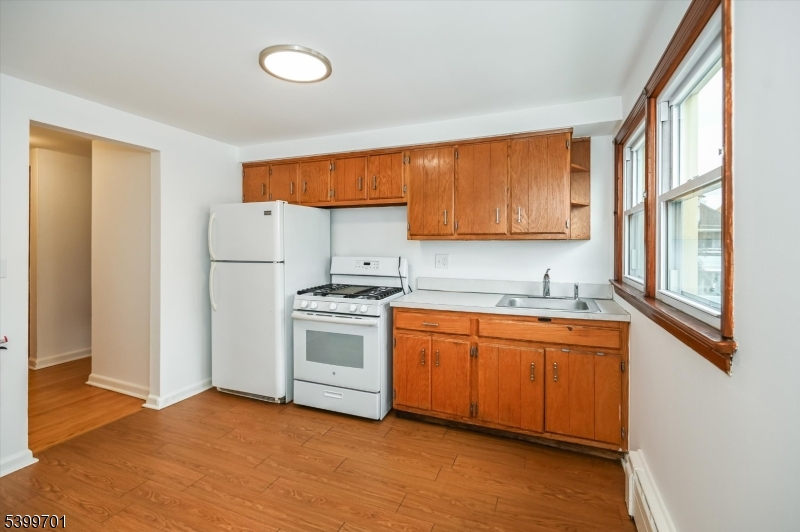 13 Knapp Avenue Clifton, NJ 07011 - Photo 9 of 17 a kitchen with stainless steel appliances granite countertop a stove a sink and a refrigerator