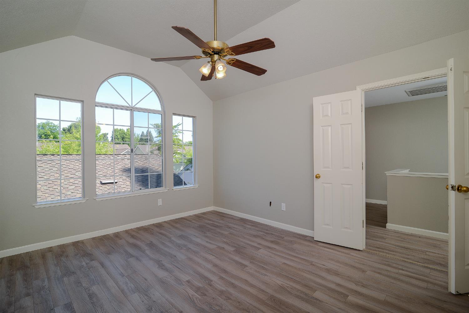 4055 Alex Lane Carmichael, CA 95608 - Photo 15 of 47 an empty room with wooden floor fan and windows