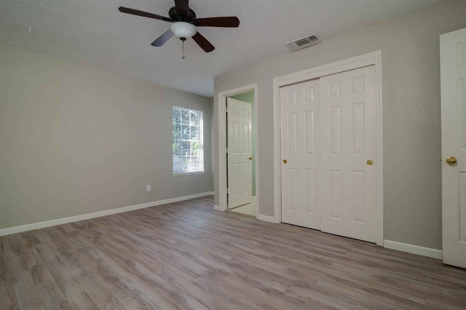 4055 Alex Lane Carmichael, CA 95608 - Photo 19 of 47 a view of empty room with wooden floor and ceiling fan