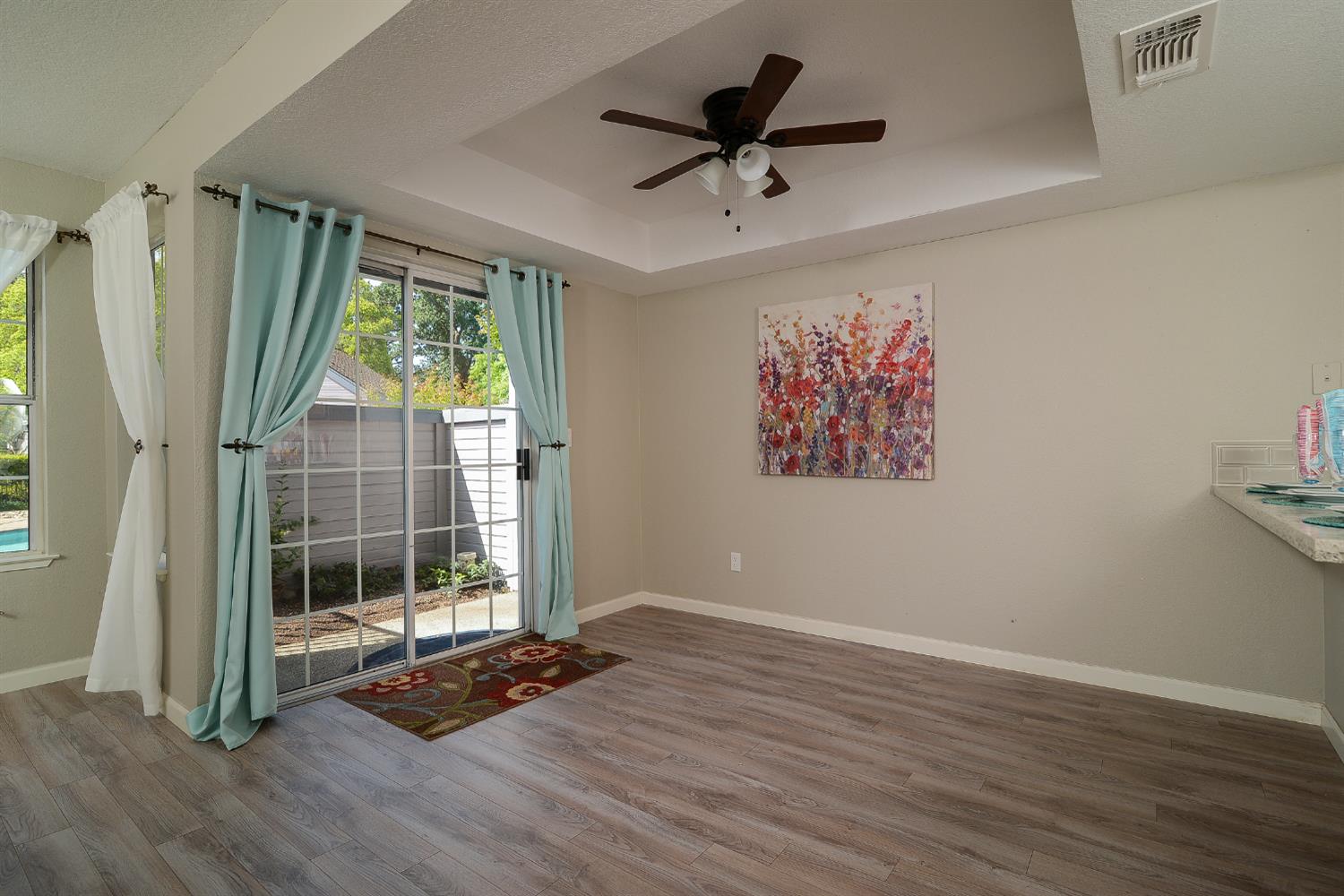 4055 Alex Lane Carmichael, CA 95608 - Photo 9 of 47 a view of an empty room with wooden floor and a window