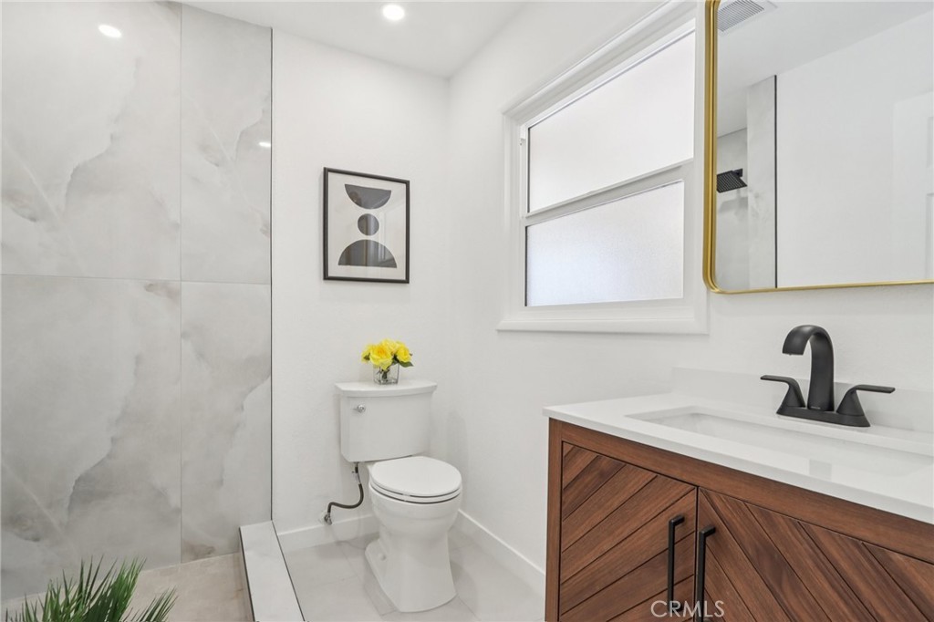 11060 Vanda Way Sun Valley, CA 91352 - Photo 14 of 43 a bathroom with a toilet sink and mirror
