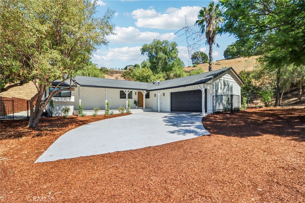 11060 Vanda Way Sun Valley, CA 91352 - Photo 2 of 43 a front view of a house with a yard and garage