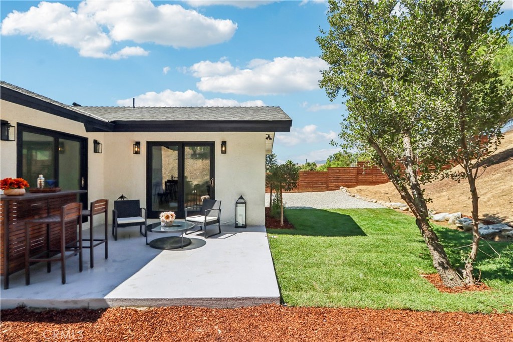 11060 Vanda Way Sun Valley, CA 91352 - Photo 26 of 43 a view of a patio with table and chairs potted plants and a large tree
