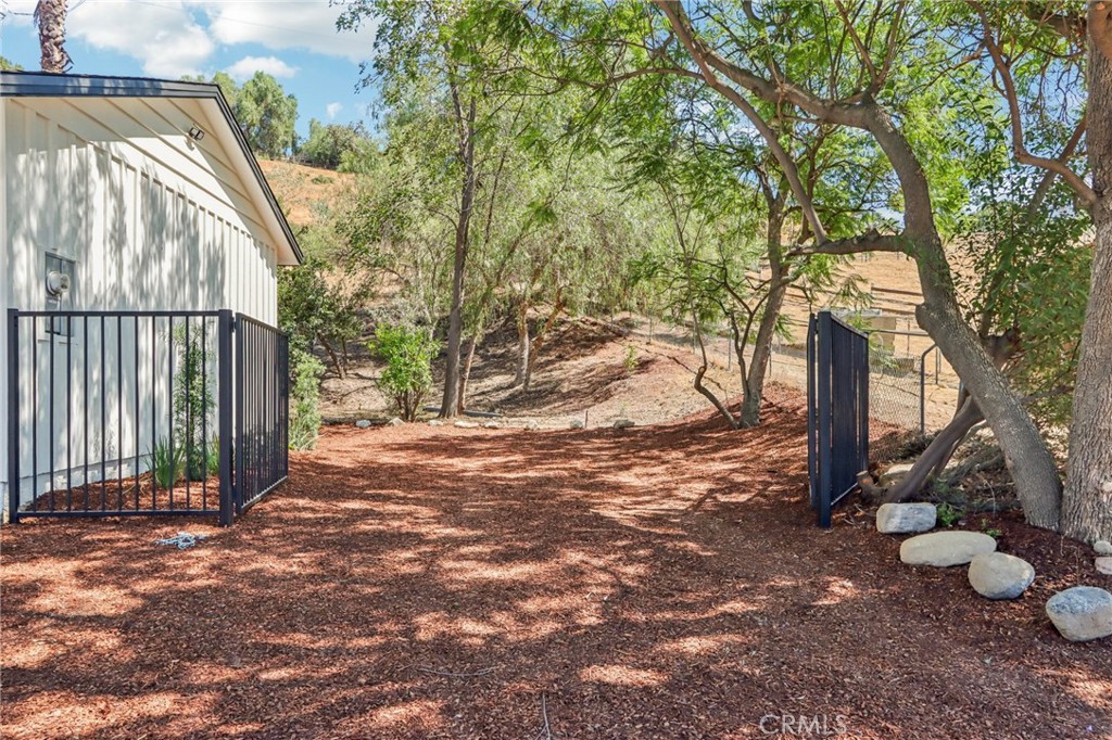 11060 Vanda Way Sun Valley, CA 91352 - Photo 30 of 43 a view of a backyard with wooden fence and a large tree