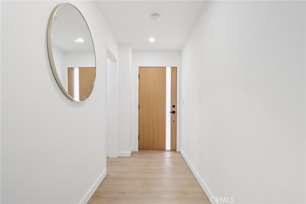 11060 Vanda Way Sun Valley, CA 91352 - Photo 3 of 43 a view of a hallway with wooden floor and a bathroom