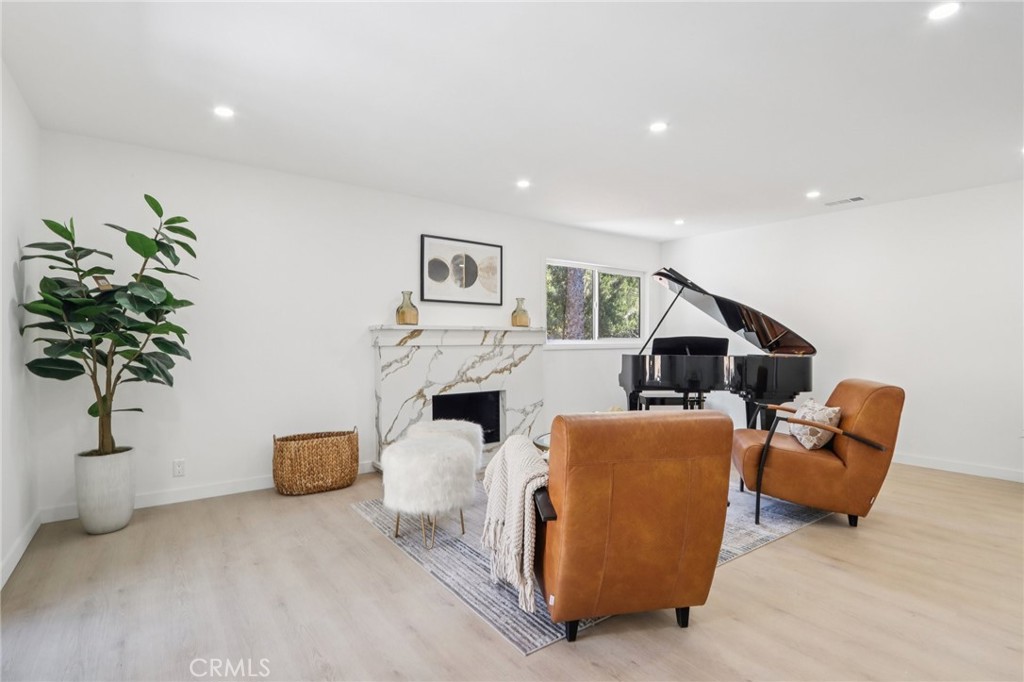 11060 Vanda Way Sun Valley, CA 91352 - Photo 4 of 43 a living room with furniture a fireplace with potted plants