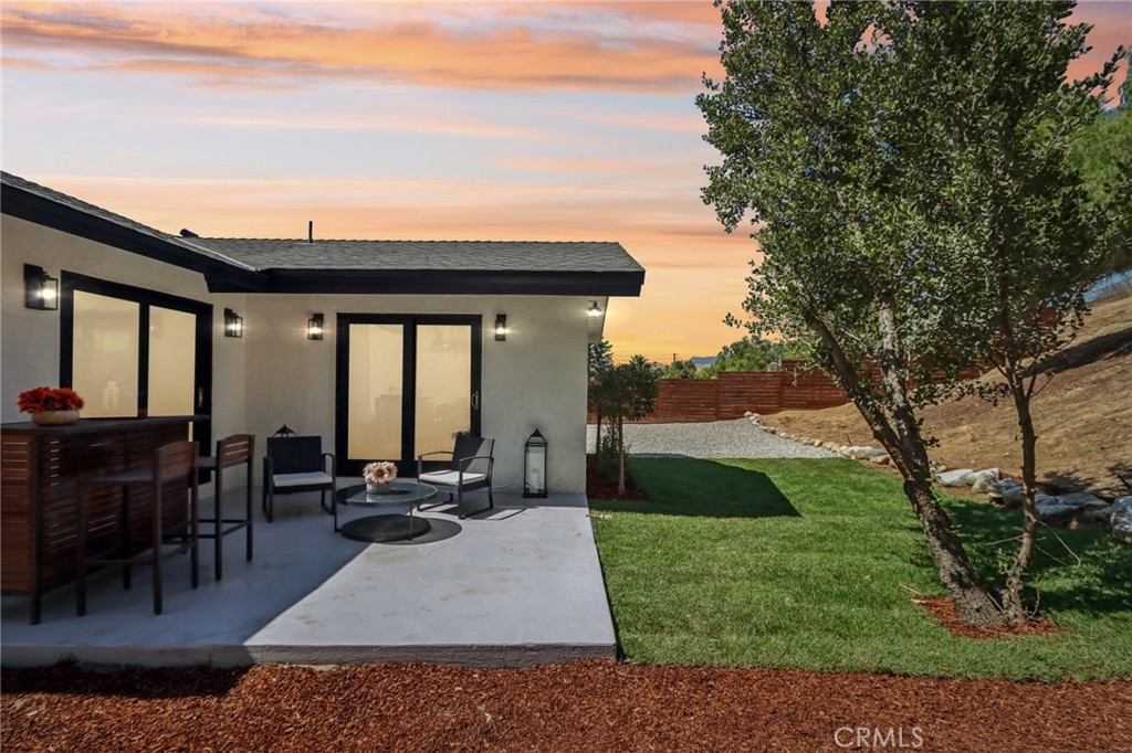 11060 Vanda Way Sun Valley, CA 91352 - Photo 42 of 43 a view of a patio with table and chairs couches plants and large trees